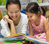 a mom and daughter read a book together