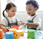 boy and girl playing with colorful cups