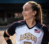 Eliana Mason standing outside in her team USA uniform with her hand on her hip