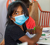 Young girl participates in an activity at the migrant education art camp in Astoria