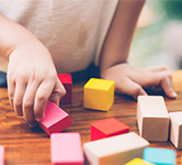 child plays with blocks