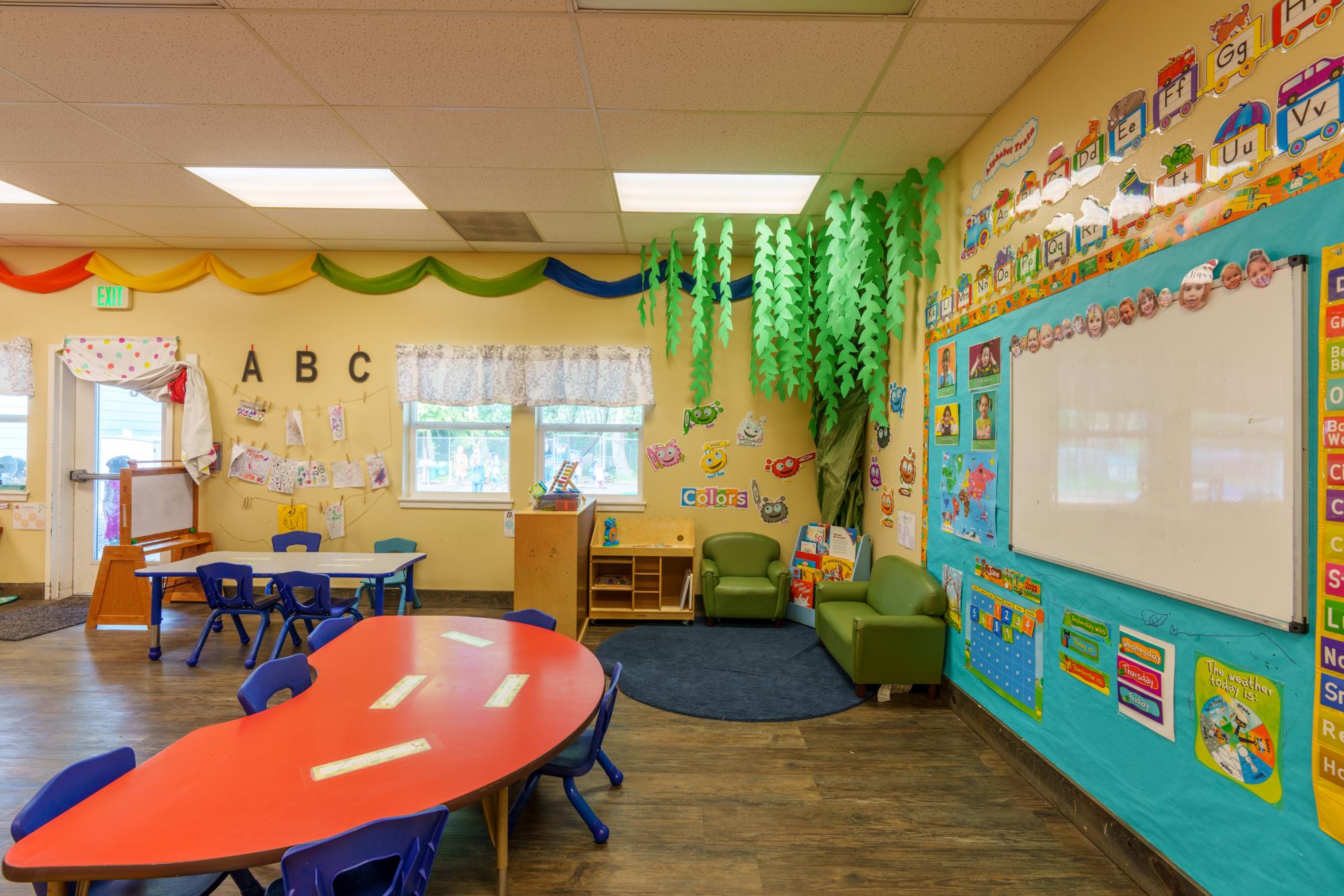 Preschool classroom at Tillamook Early Learning Center shows tables and wall art