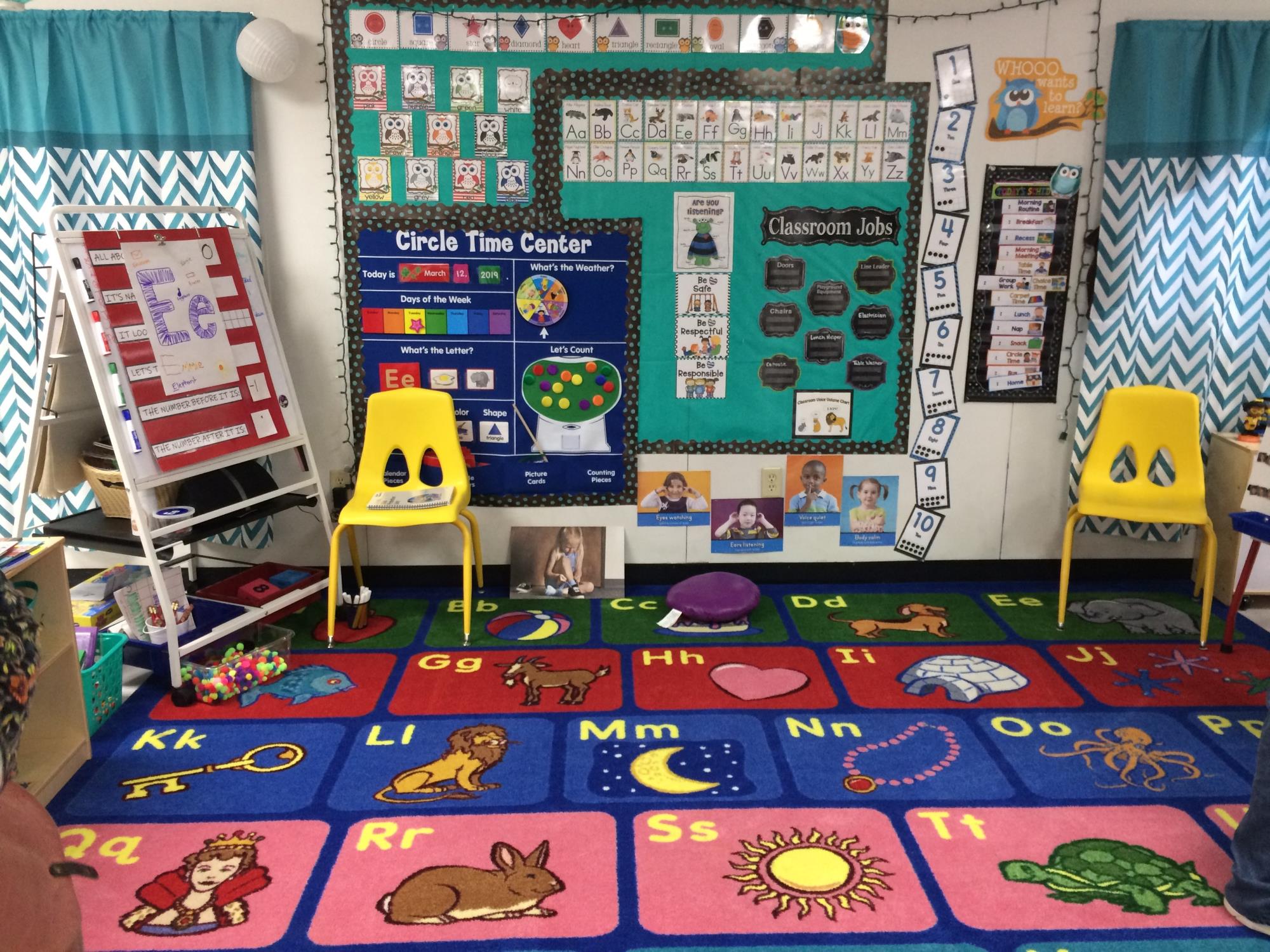 Rainier Preschool circle time area includes colorful carpet and classroom materials