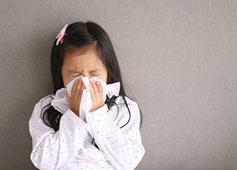 girl blowing her nose