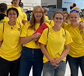 students stand with their teacher at the Oregon Manufacturing Innovation Center