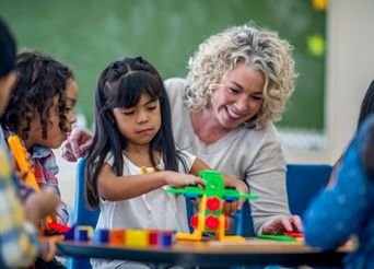 teacher working with students