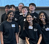 high school students in black t-shirts pose for a photo