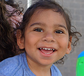 toddler smiles for the camera