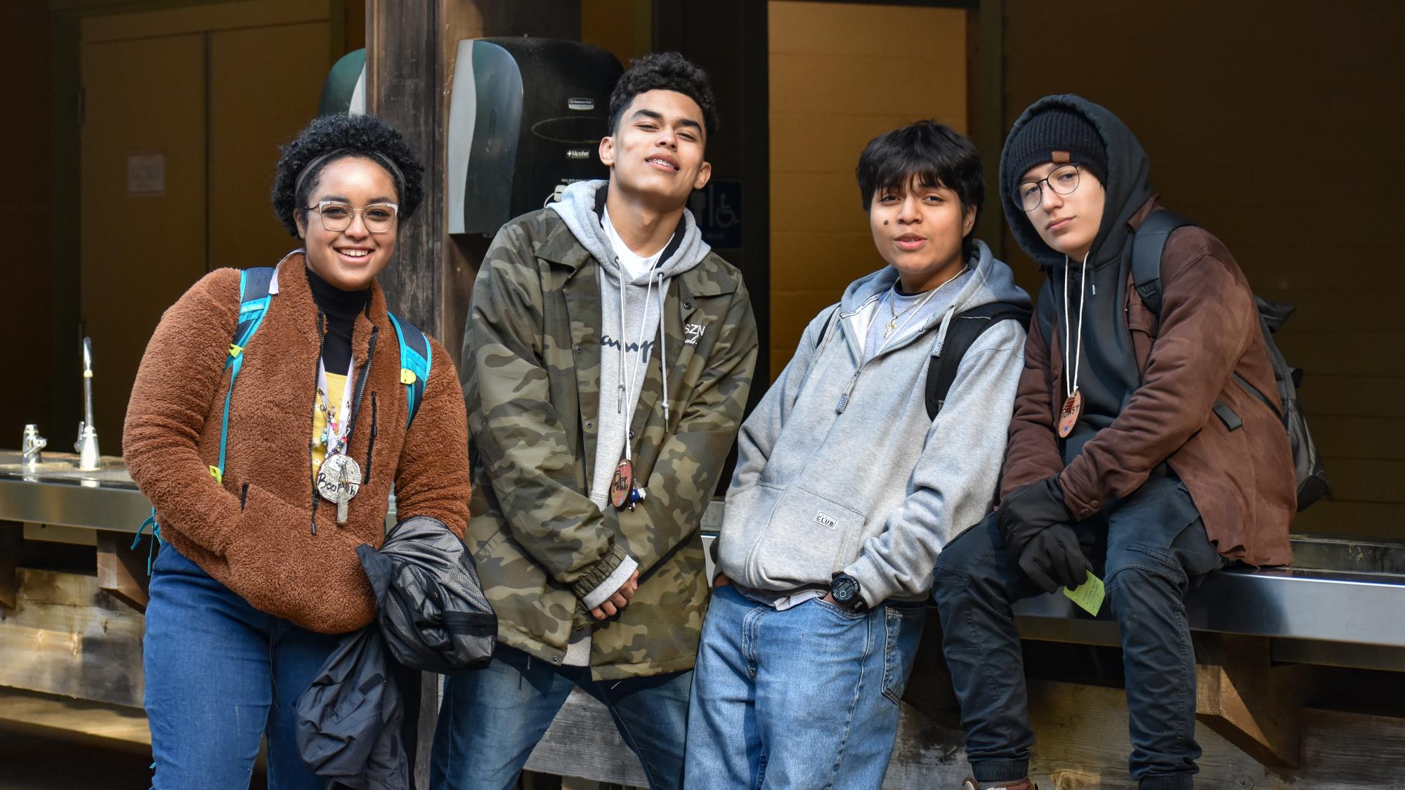 four high school students pose for a photo