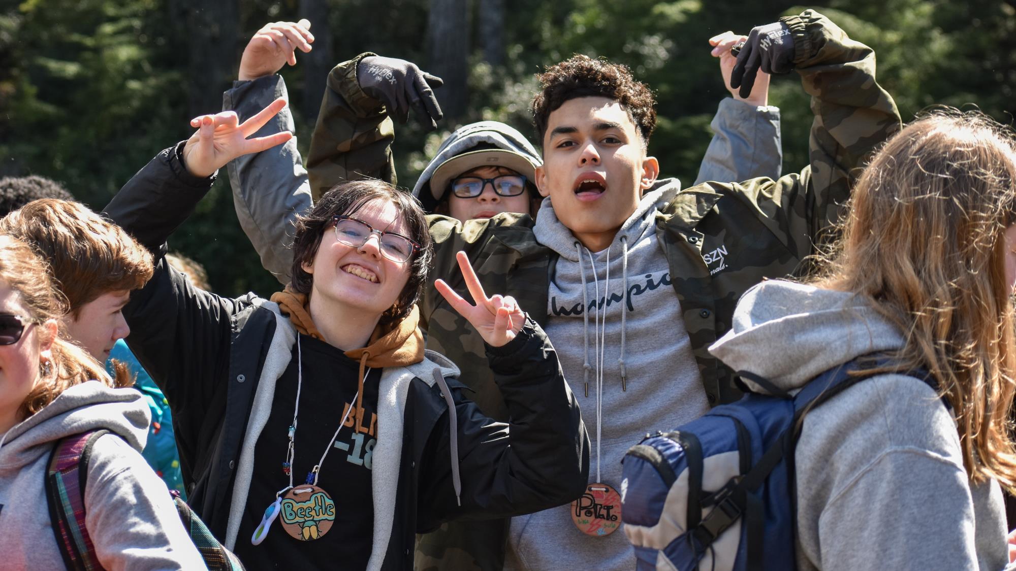 student leaders pose for a photo with their arms in the air