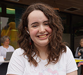 Hannah poses for a photo outside Cascade and Pacific academies