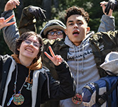 student leaders pose for a photo with their arms in the air