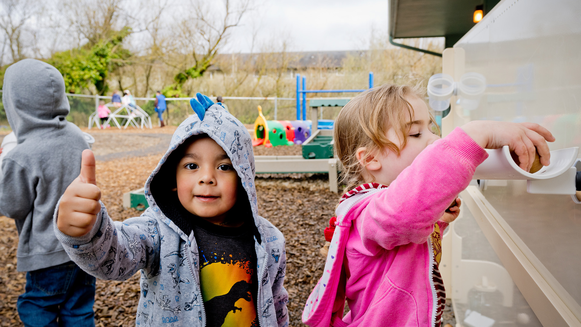 student gives a thumbs up on the playground