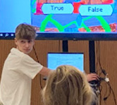 a student runs the display screen and looks at a judge