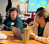 two educators share ideas in a conference room