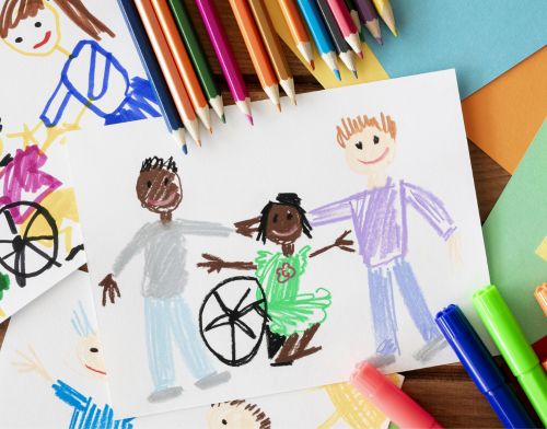 crayon drawing of three children with colored pencils nearby