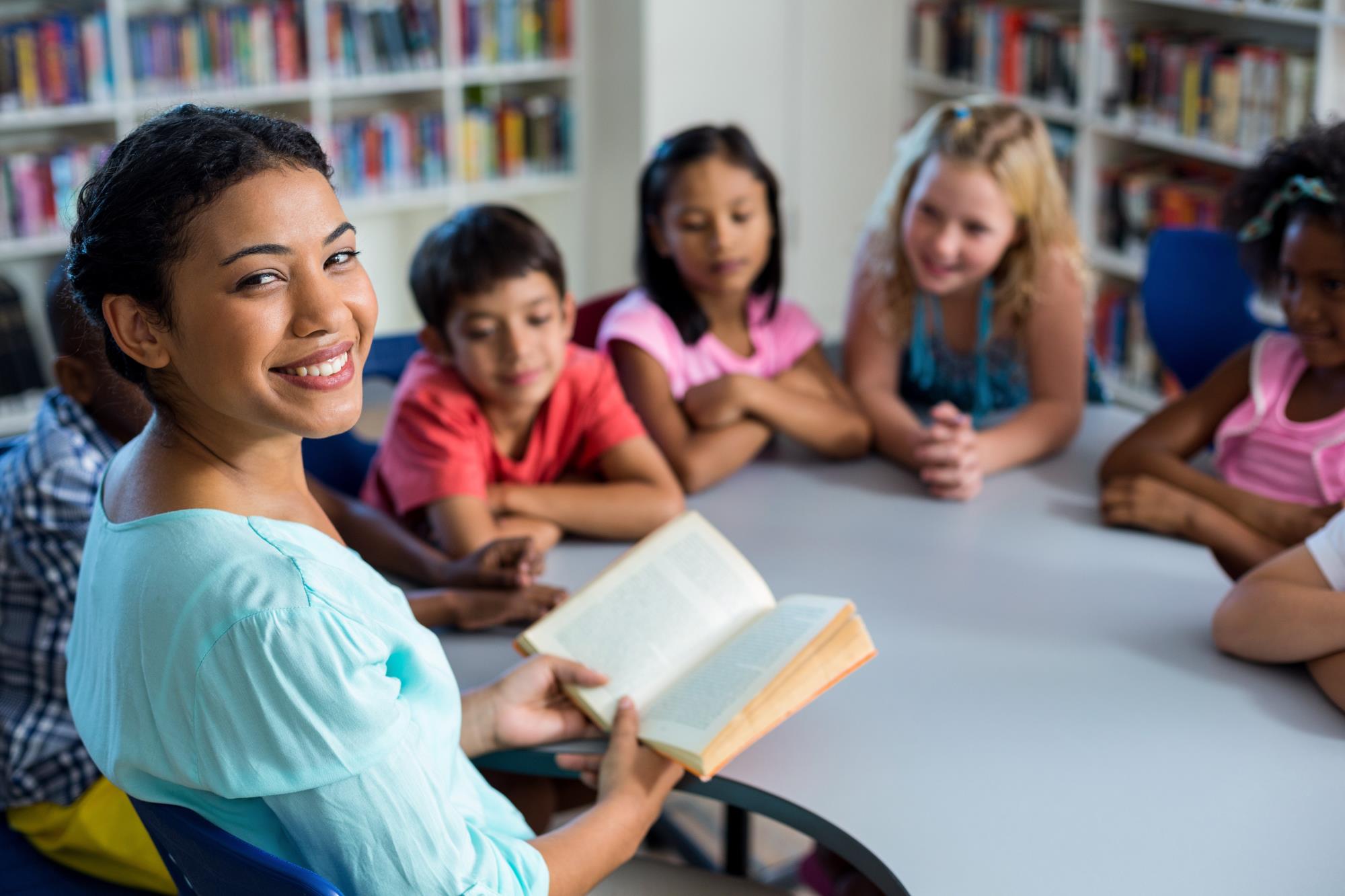 Teacher reading to a group of students