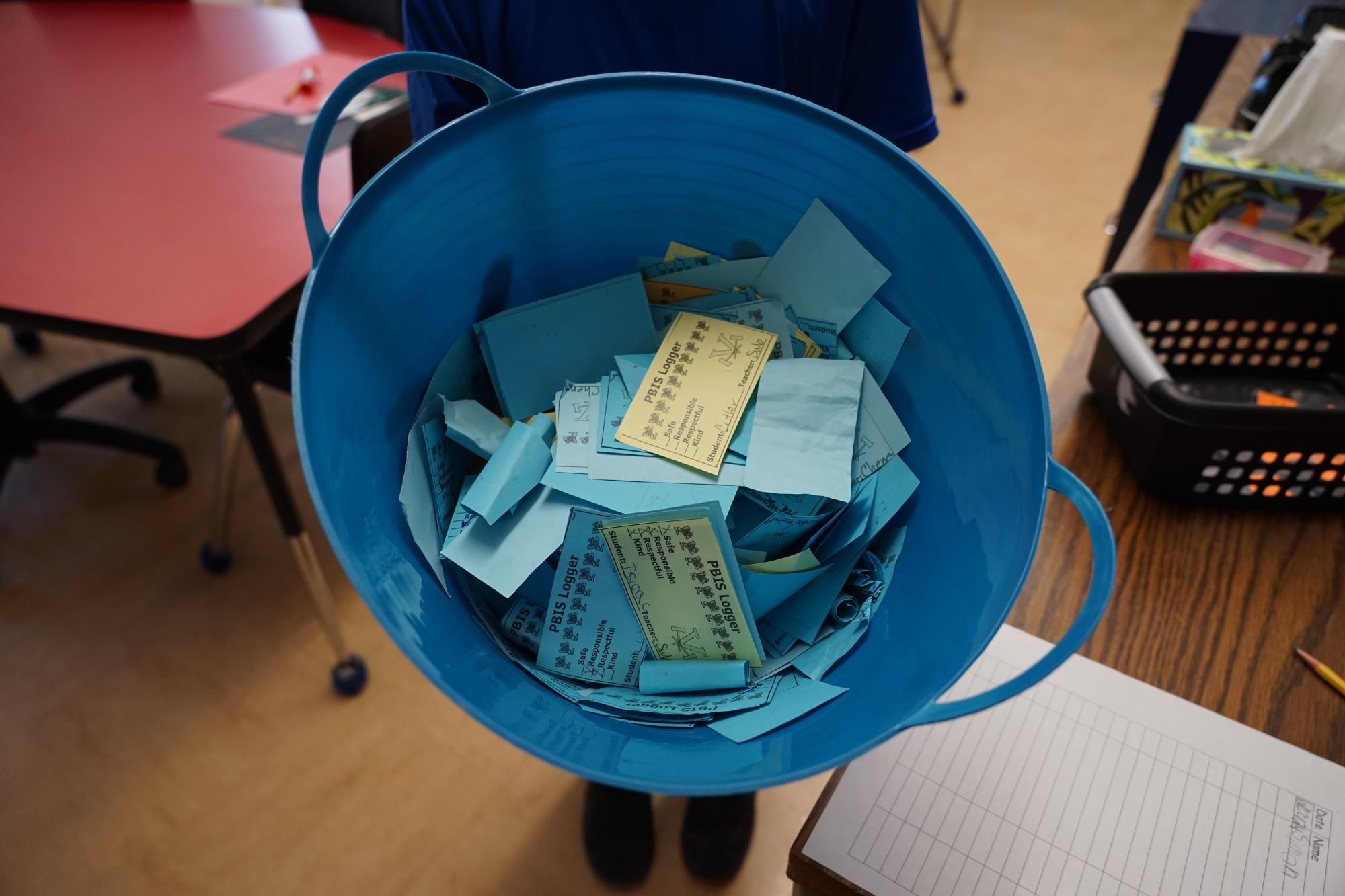 a blue bin with blue and yellow logger cards